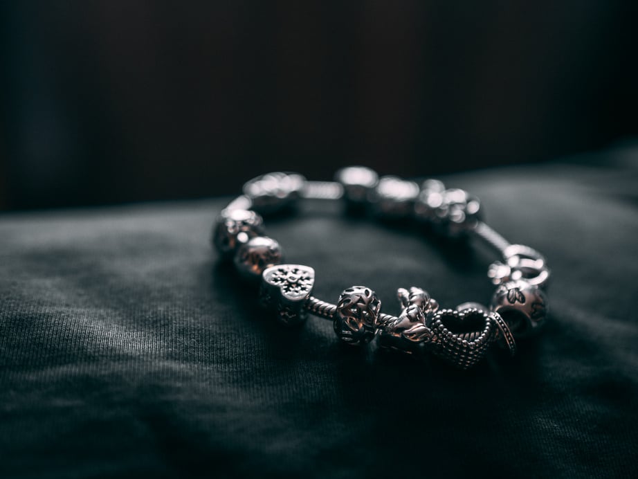 Silver Bracelet With Charms On Black Textile